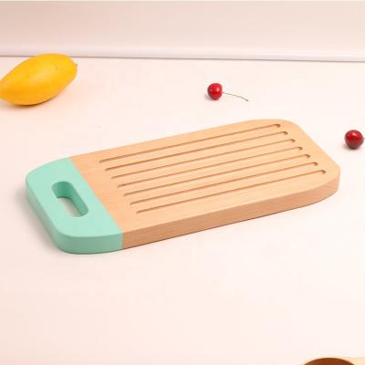 China Amazon Sales Sustainable Wonderful Custom Made Cheese Board Wooden Cutting Board With Silicone Handle for sale