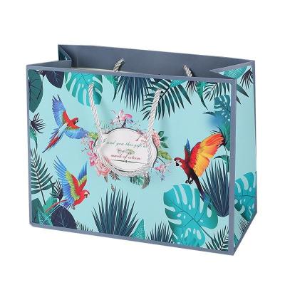 China Wholesale luxury cosmetics recyclable JuYi flowers and birds forest pattern clothing and shoes shopping waterproof paper bag for sale