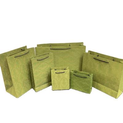 China JuYi Recyclable Luxury Brand Custom Logo Clothes Gift Bag Green Matte Garment Perfume Lipstick Packaging Bags With Ribbon Handles for sale