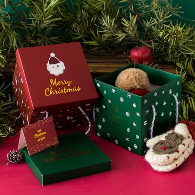 China Custom Printing Recyclable Red Green Luxury Recycled Cubic Foldable Christmas Paper Candy Boxes Merry Christmas Cubic Foldable Packing Gift Box With Cover for sale