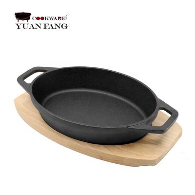 China Sustainable Mini Oval Cast Iron Fajita Skillet, Sizzler Plate With Wood Base for sale