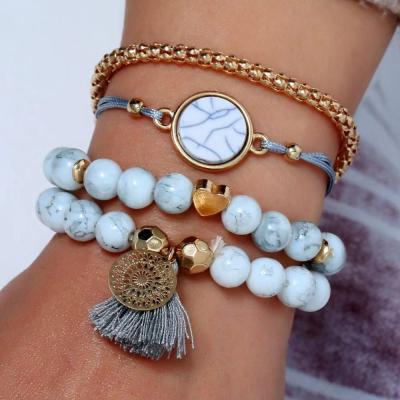 China Fashion metal hollow flower turquoise bead tassel charm bracelet set wholesale for sale