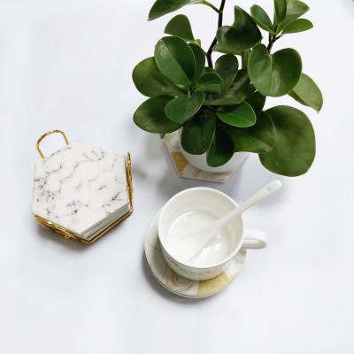 China Custom Hexagon Stocked Around Gold Water Absorbent Ceramic Coaster With Stand for sale