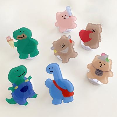 China New Style CIA Dinosaur Adjustable Cute Cartoon Korean Epoxy Lazy Retractable Stand Mobile Phone Holder Small for sale