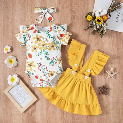 China Anti-Shrink Floral Short Sleeve Romper Plain Ruffle Snap Suspender Pleated Short Skirt Bow Headband Set Infant Girls 3Pcs Romper Costume for sale