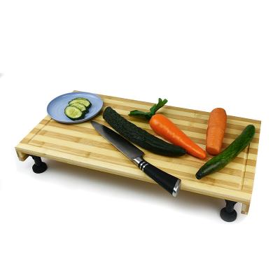 China Sustainable Dual-purpose Chopping Board Bamboo and Stovetop Cover Cutting Board with Adjustable Legs for sale