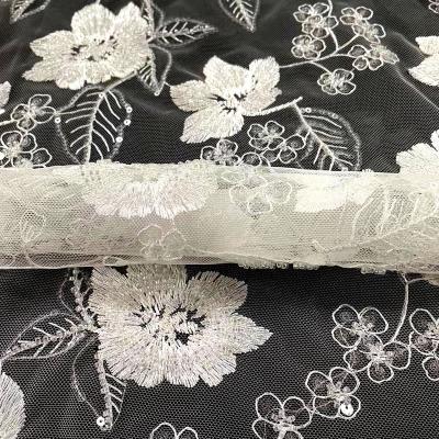 China Sustainable Beautiful Flowers Pattern White Stone Beads And Sequins Embroidery Fabric for sale