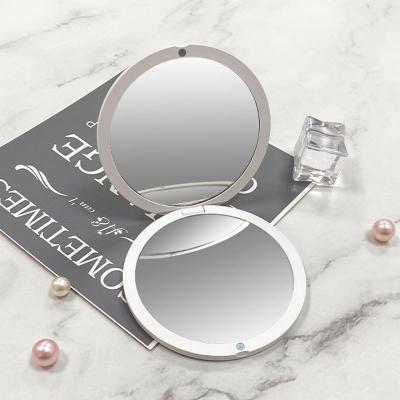 China Customized Lighted Logo Simple Small Mirror Folding Round Mirror Mirror Makeup Customized Portable Color Double Sided Folding Mirror for sale