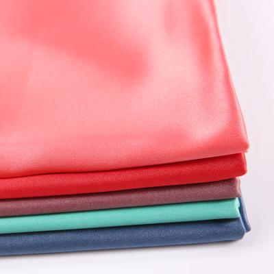 China Good Low Price Polyester Textiles Good Low Price Silky American Alex Satin Plain Dyeing Fabric for sale