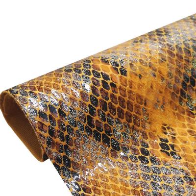 China New Trend Waterproof Snakeskin Wholesale Grain Recycled Artificial Leather Fabric for sale