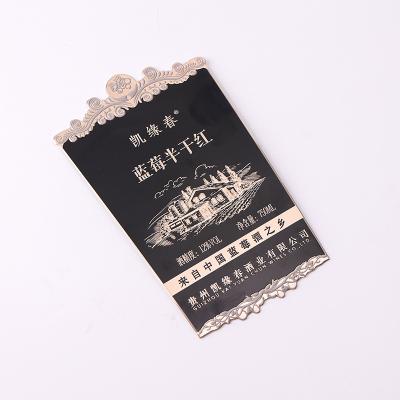 China Waterproof custom aluminum embossed bottle logo label metal sticker metal wine bottle label for sale