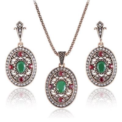 China Vintage Fashion Cheap Antique Gold Oval Shape Emerald Ruby Crystal Rhinestone Necklace And Earring Sets For Women for sale