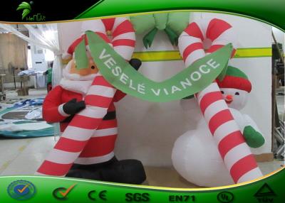 China Waterproof Inflatable Holiday Decorations Christmas Candy Cane Arch With Santa for sale