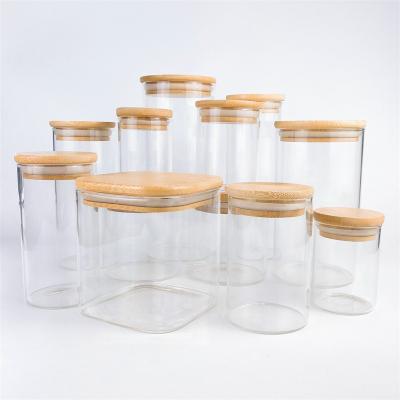 China Household Products Empty Transparent White Glass Candle Jars With Wooden Lid For Candles for sale