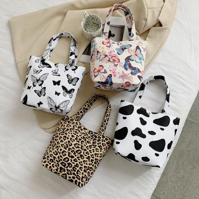 China Low MOQ Portable Cute Cartoon Butterfly Bag Student Creature Leopard Dairy Cattle Print Cloth Canvas Handy Bag for sale