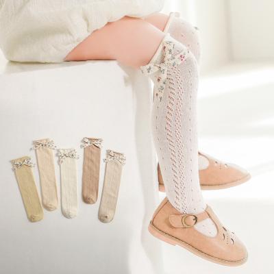 China Popular Hot Selling Movable Bow Children's Mesh Hollow Ring Spring Princess Breathable Socks Combed Cotton Girl Stockings for sale