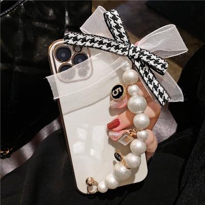 China Luxury 3D Shockproof Electroplate Soft Pearl Wrist Strap Arc Lanyard Phone Case For Huawei P50 Pro Fashion Cover for sale