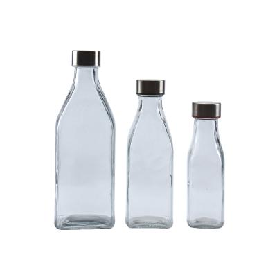 China Sustainable Glass Drinking Bottles Place For Beverage And Juice Portable Water Bottle Glass With Metal Lid for sale