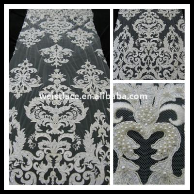 China Viable Gorgeous White Lace Fabric Embroidered Bridal Lace Textile Handmade Pearl Lace For Wedding Dress for sale