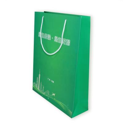 China Recycled Materials Xilong New Gift Clothing Shopping Bag Green Portable Cardboard Paper Bag With Handle for sale