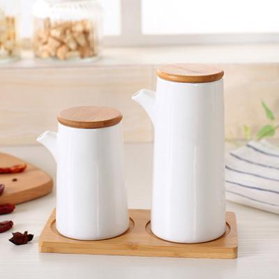 China Viable White Ceramic Soy Sauce Kitchen Container Porcelain Bottle Spice Seasoning Jar Set Of Two for sale