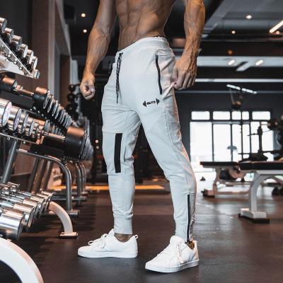 China Wholesale Cheap QUICK DRY Male Sports Pants Outdoor Casual Running Pure Color Elastic Trackpants Sweatpants Fitness for sale