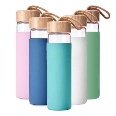 China 2022 Viable Custom Hot Sale 20oz Doyoung Sports Bamboo Lid Drinking Glass Water Bottle With Silicone Sleeve for sale