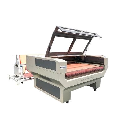 China Water Cooled 1610 Leather Textile Auto Feeding Cloth Advertising Banners CO2 Laser Cutting Machines Cutter for sale