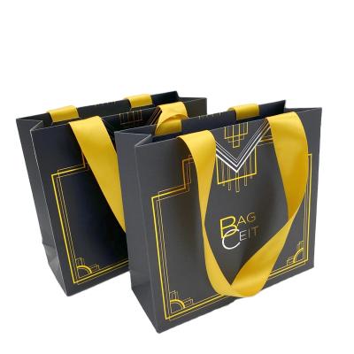 China 210g sliver coated paper high quality custom made recyclable handle small black paper bags with logo for sale