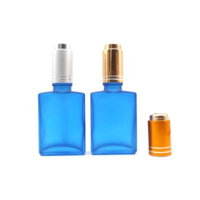 China Customized Personal Care 30ml 1oz Blue Frosted Rectangular Glass Cosmetilc Serum Bottle With Push Pump Dropper Cap for sale