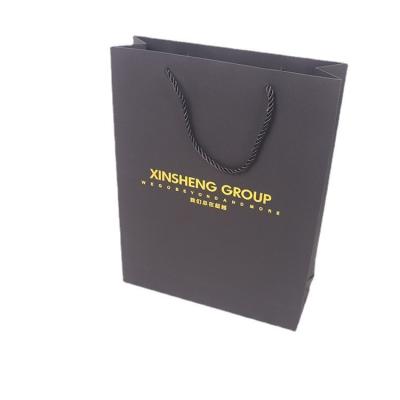 China Recycled Materials Wholesale Custom Printed Black Tan Luxury Shopping Paper Bag With Handle for sale