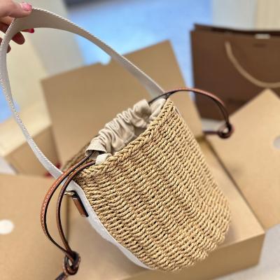 China Other Wholesale Women's Holiday Weave Raffia Bucket Bag Summer Fashion Beach Luxury Handmade Famous Bolso de mujer Bags Tote for sale