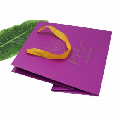 China Recyclable Custom Luxury Purple Coated Paper Bag For Clothing Cosmetic Wigs Gift Packaging Paper Bag for sale