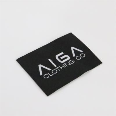 China Viable Custom Hot Sale Private Black Polyester Patches Base White Woven Labels For Apparel/Jeans/Bag/Shirt With Tape Your Logo for sale