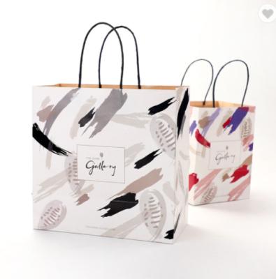 China Recycled Materials Printing Foldable White Kraft Paper Gift Bag With Logo for sale