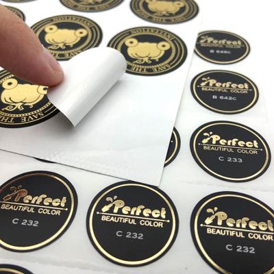 China Anti-Counterfeiting Custom Gold Foil Hot Stamping Self Adhesive Transparent Round Label Stickers for sale