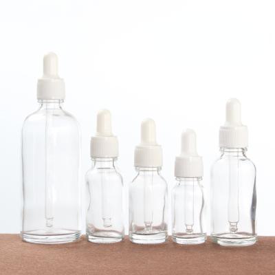 China Cosmetic in stock empty clear glass dropper essential oil bottle for cosmetic packaging for sale