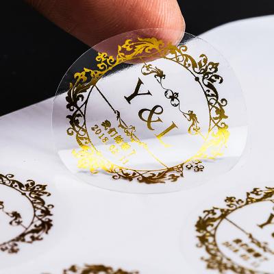 China Wholesale Custom Waterproof PVC Logo Gold Hot Stamping Transparent Packaging Sticker for sale