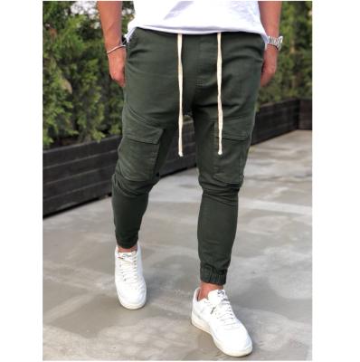 China New Hot Selling Ins Muscle Anti-Wrinkle Muscle Men's Slim Sports Pants Shape Bodybuilding Casual Sports Overall Feet Multi-pocket Running Pants for sale