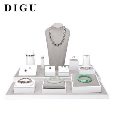 China DIGU Modern Luxury Jewelry Counter Display Props PU Leather Jewelry Display Set Ring Pendant Bracelet Necklace Display Tray for sale