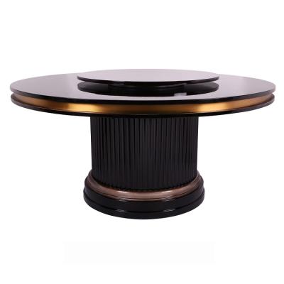 China Extendable modern luxury dining table with gold leaf and ebony leather facing stainless steel turntable for sale