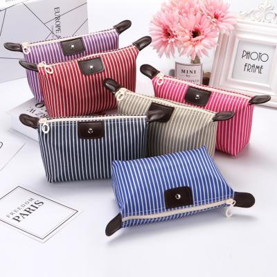 China Fashoion Cassette Bag Striped Dumpling Makeup Bag Foldable Makeup Bag With Large Capacity for sale