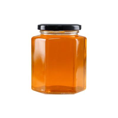 China Wholesale Custom Hexagon Shape Empty Food Storage Jar Glass Honey Jar With Metal Lid for sale