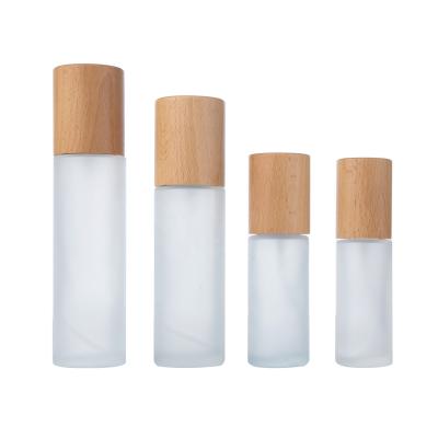 China 30ml 50ml 100ml 120ml Cosmetic Cosmetic Glass Bottle With Wooden Cap And Wooden Pump Biodegradable Wooden Cosmetic Packaging for sale