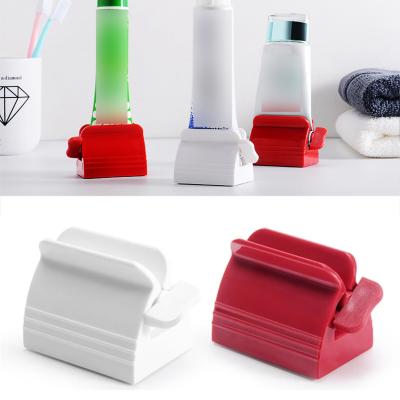 China Portable Plastic Squeezer Multifunctional Holder Tube Toothpaste Detergent Dispenser Portable Bathroom Accessories for sale