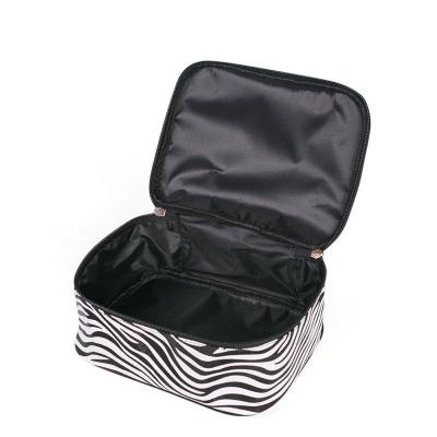 China Fashion Small Travel Zebra Pattern Cosmetic Bag Portable PU Granule Cosmetic Bag for sale