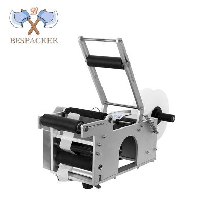 China Bespacker MT-50 Semi Automatic Drink Round Juice Plastic Bottle Paper Sticker Pet Bottles Cans Labeling Machine for sale