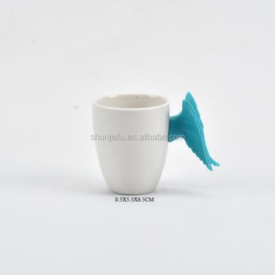 China Viable Wholesale New Style Ceramic Coffee Mug with Silicone Angel Wing Handle for sale