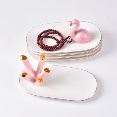 China Eco-friendly Personalized Ceramic Jewelry Diamond Conicalness Design Edge Gold Oval Jewelry Tray for sale