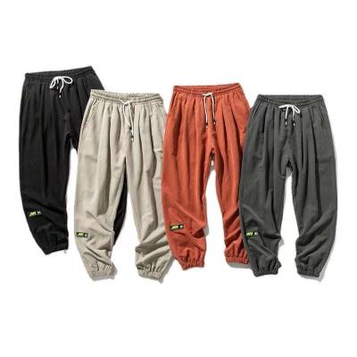 China Fashionable Anti-Wrinkle Cargo Breeches Men Pants Fattening Casual Sweatpants Plus Size Sweatpants Elastic Band for sale